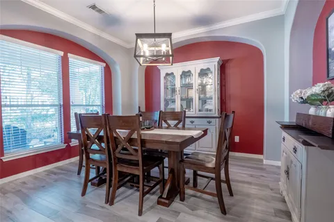 a view of a dining room with furniture and chandelier