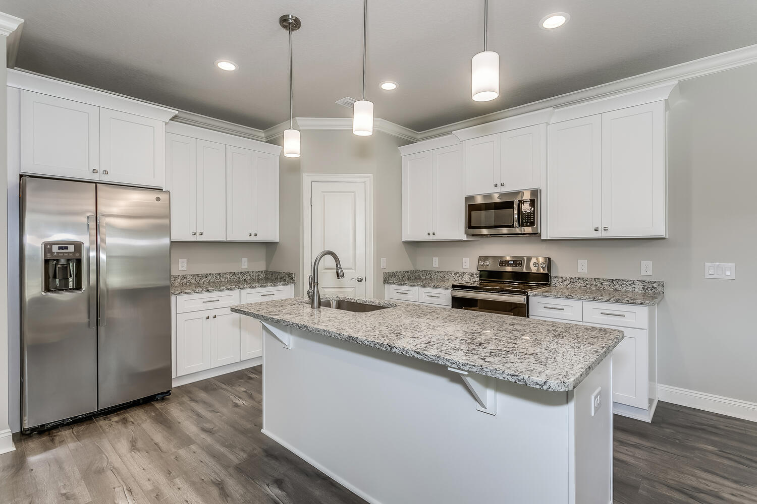 6695 Rocky Shores Road Milton, FL 32583 - Photo 12 of 53 a kitchen with stainless steel appliances granite countertop a sink a stove a refrigerator and island with wooden floor
