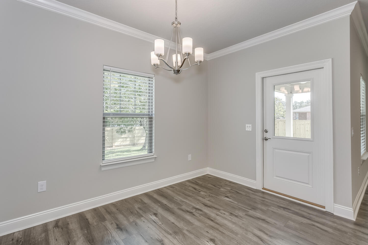 6695 Rocky Shores Road Milton, FL 32583 - Photo 15 of 53 a view of an empty room with wooden floor and a window