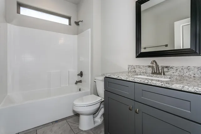 a bedroom with bed and a window