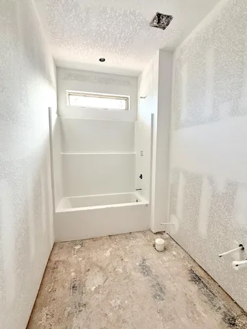 an empty room with windows and cabinet