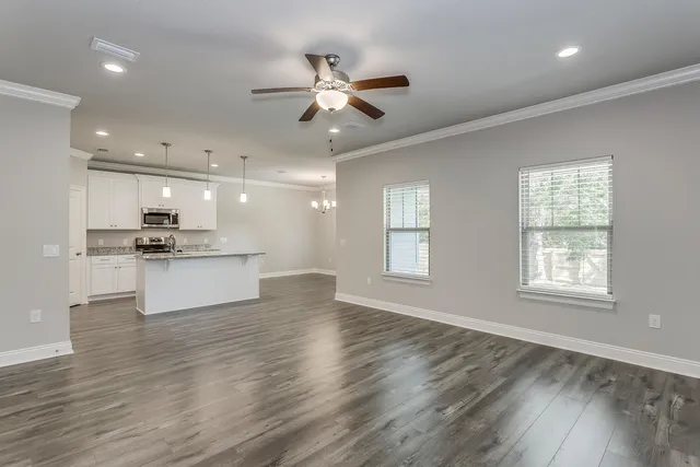 a living room with furniture kitchen and a chandelier