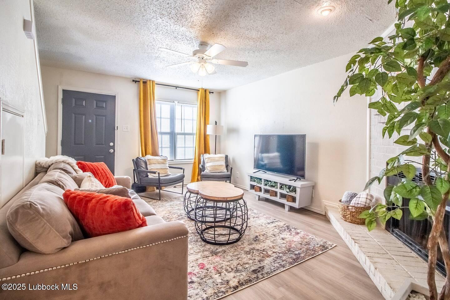 5806 6th Street, Unit B Lubbock, TX 79416 - Photo 2 of 45 a living room with furniture and a potted plant