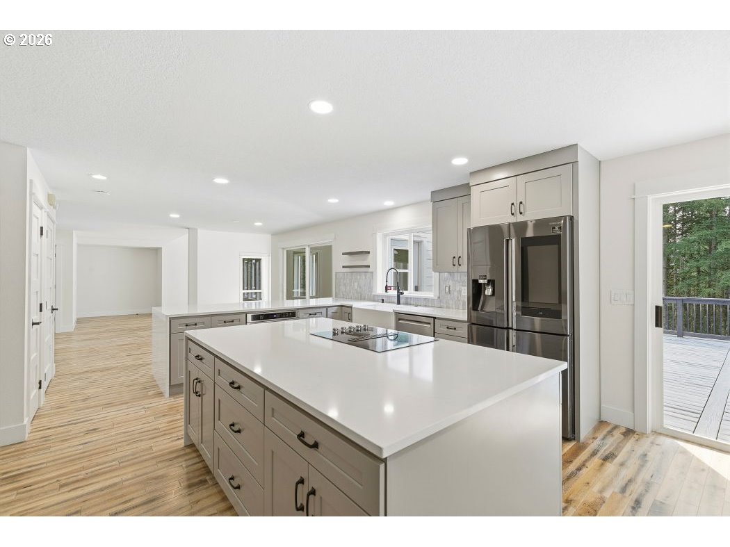 3708 Northeast 292nd Avenue Camas, WA 98607 - Photo 11 of 44 a kitchen with stainless steel appliances granite countertop a sink and a refrigerator
