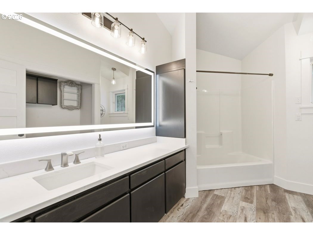 3708 Northeast 292nd Avenue Camas, WA 98607 - Photo 18 of 44 a bathroom with a sink a mirror and a bathtub