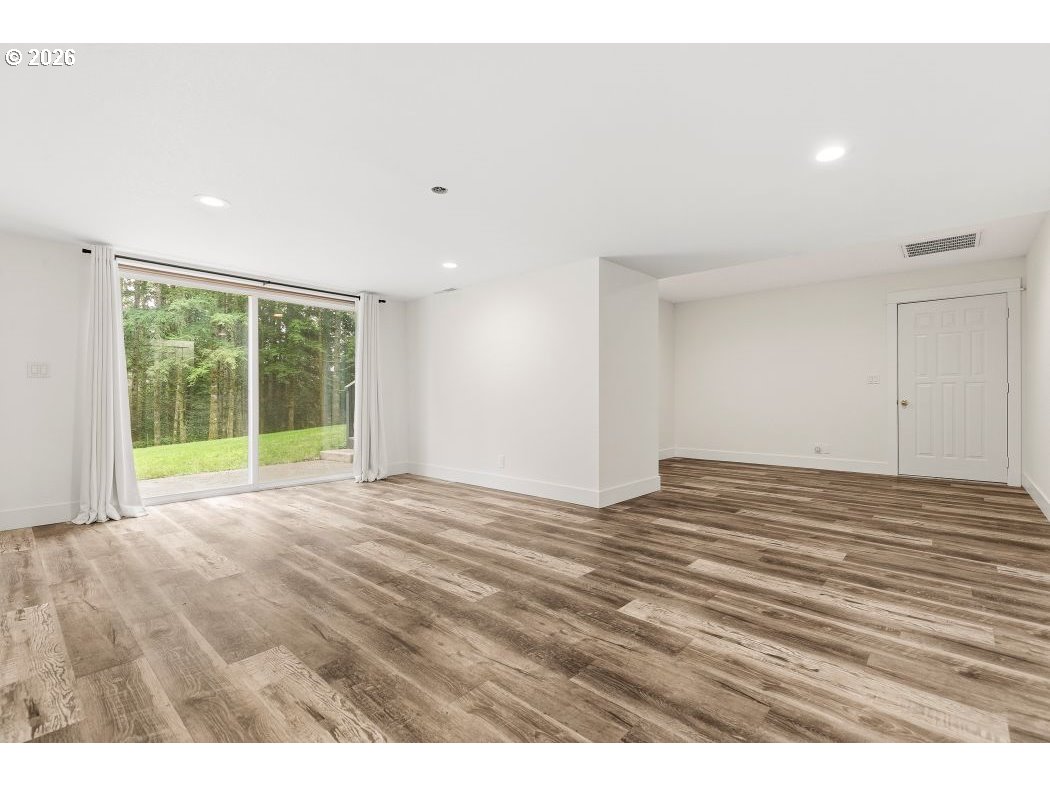 3708 Northeast 292nd Avenue Camas, WA 98607 - Photo 31 of 44 a view of an empty room with wooden floor and a window