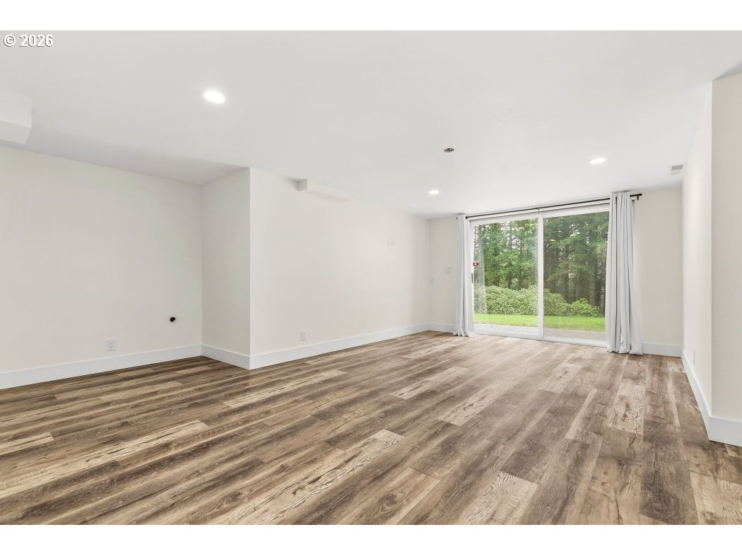 3708 Northeast 292nd Avenue Camas, WA 98607 - Photo 32 of 44 a view of an empty room with wooden floor and windows