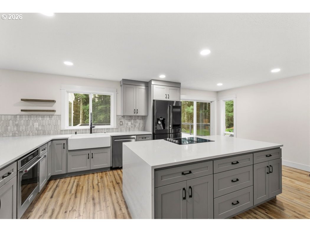 3708 Northeast 292nd Avenue Camas, WA 98607 - Photo 7 of 44 a kitchen with a sink stove and cabinets