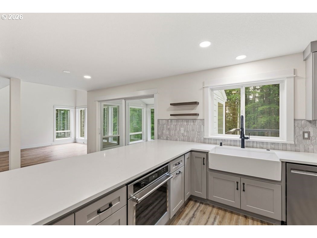 3708 Northeast 292nd Avenue Camas, WA 98607 - Photo 9 of 44 a kitchen with a sink stove and cabinets