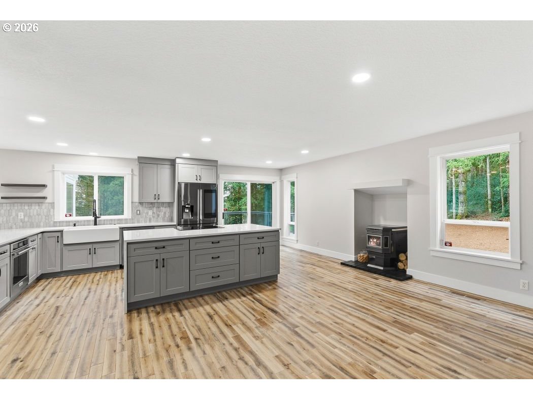 3708 Northeast 292nd Avenue Camas, WA 98607 - Photo 10 of 44 a large living room with a large window wooden floor and furniture