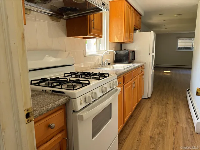 a kitchen with a stove a sink and a refrigerator