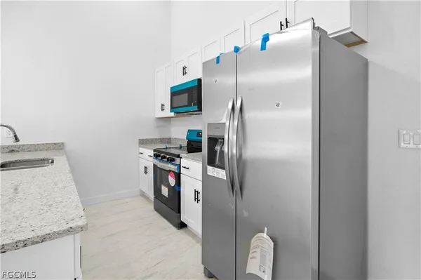a kitchen with a refrigerator and a sink