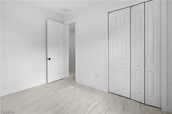 an empty room with wooden floor