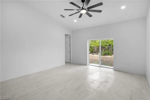 a view of a livingroom with a ceiling fan and window