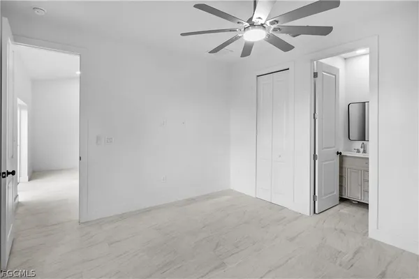 a view of a hallway with a chandelier fan