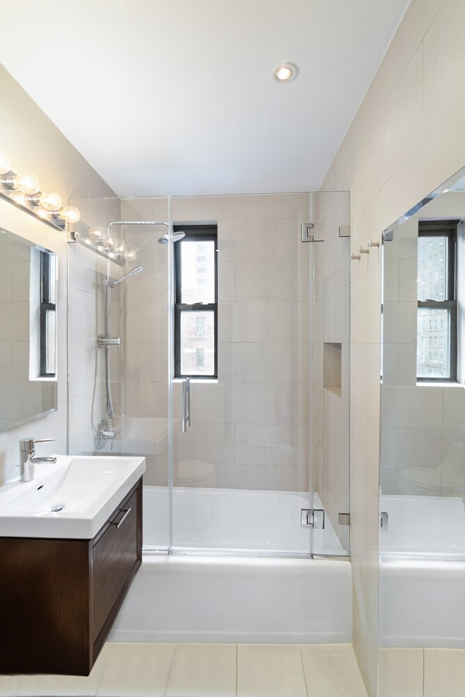 242 East 38th Street, Unit 5E Manhattan, NY 10016 - Photo 7 of 9 a bathroom with a bathtub a sink and a shower