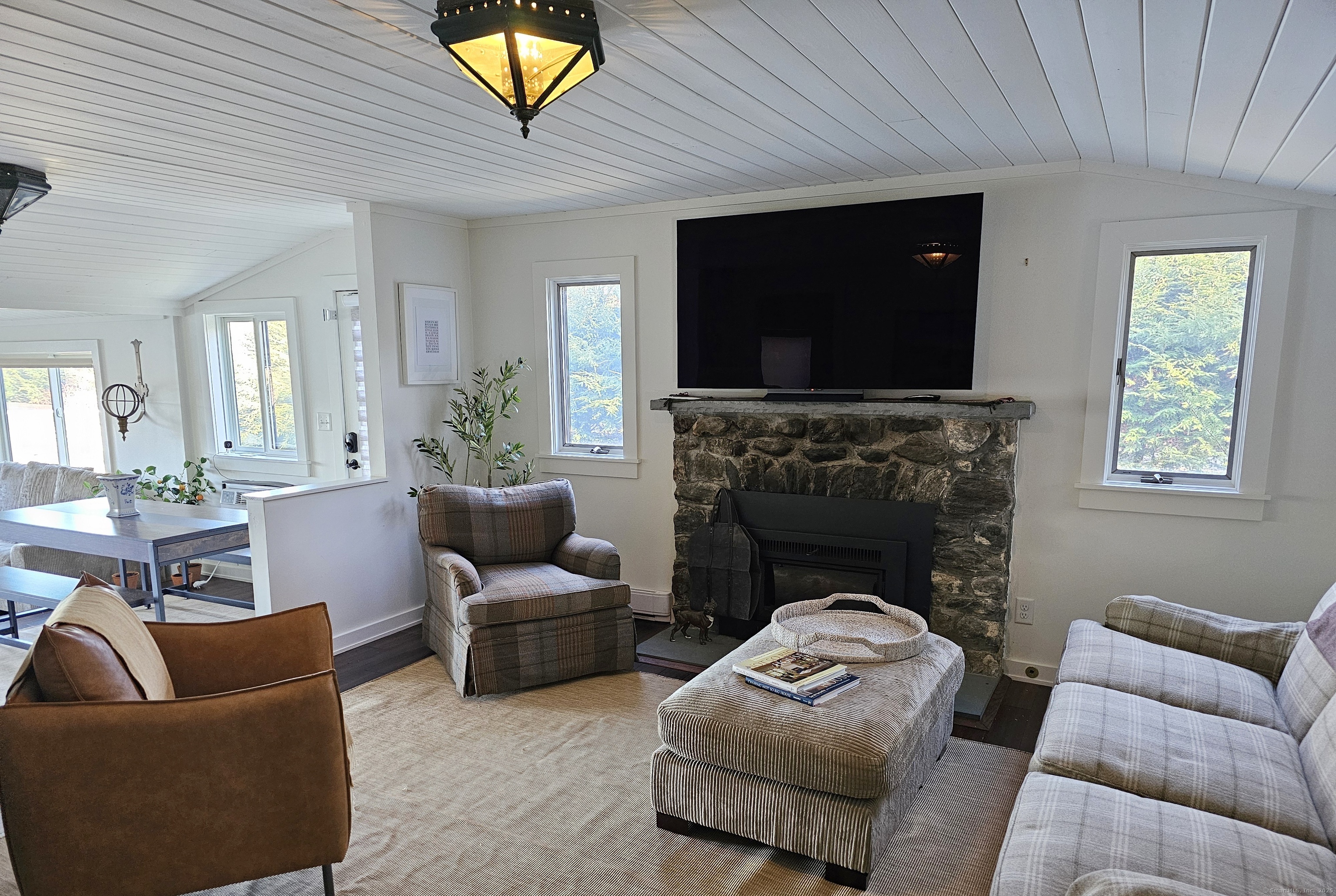 112 West Lake Road, Unit 112 Woodbury, CT 06798 - Photo 11 of 34 a living room with furniture a flat screen tv and a fireplace