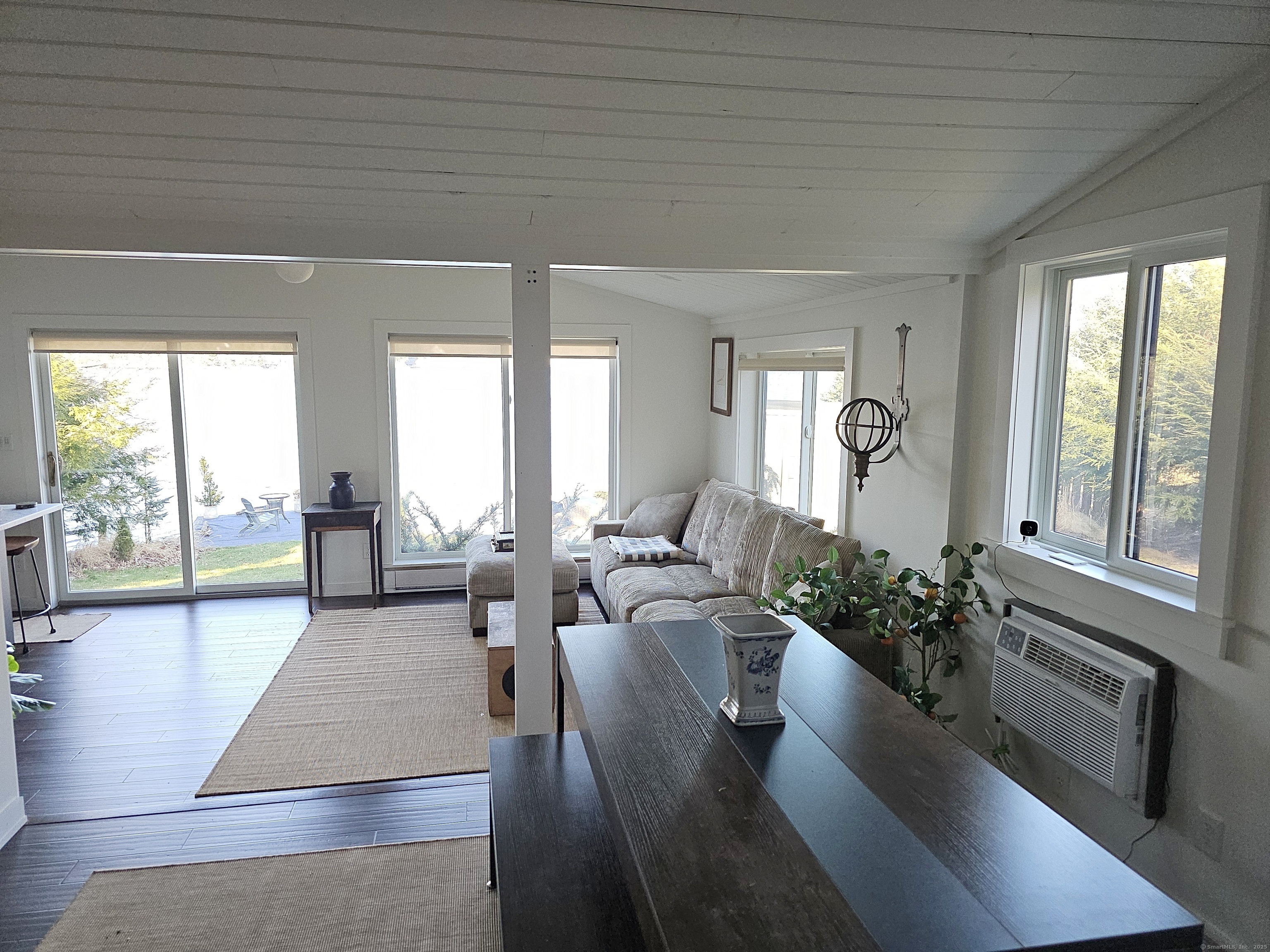 112 West Lake Road, Unit 112 Woodbury, CT 06798 - Photo 12 of 34 a living room with furniture large windows and wooden floor