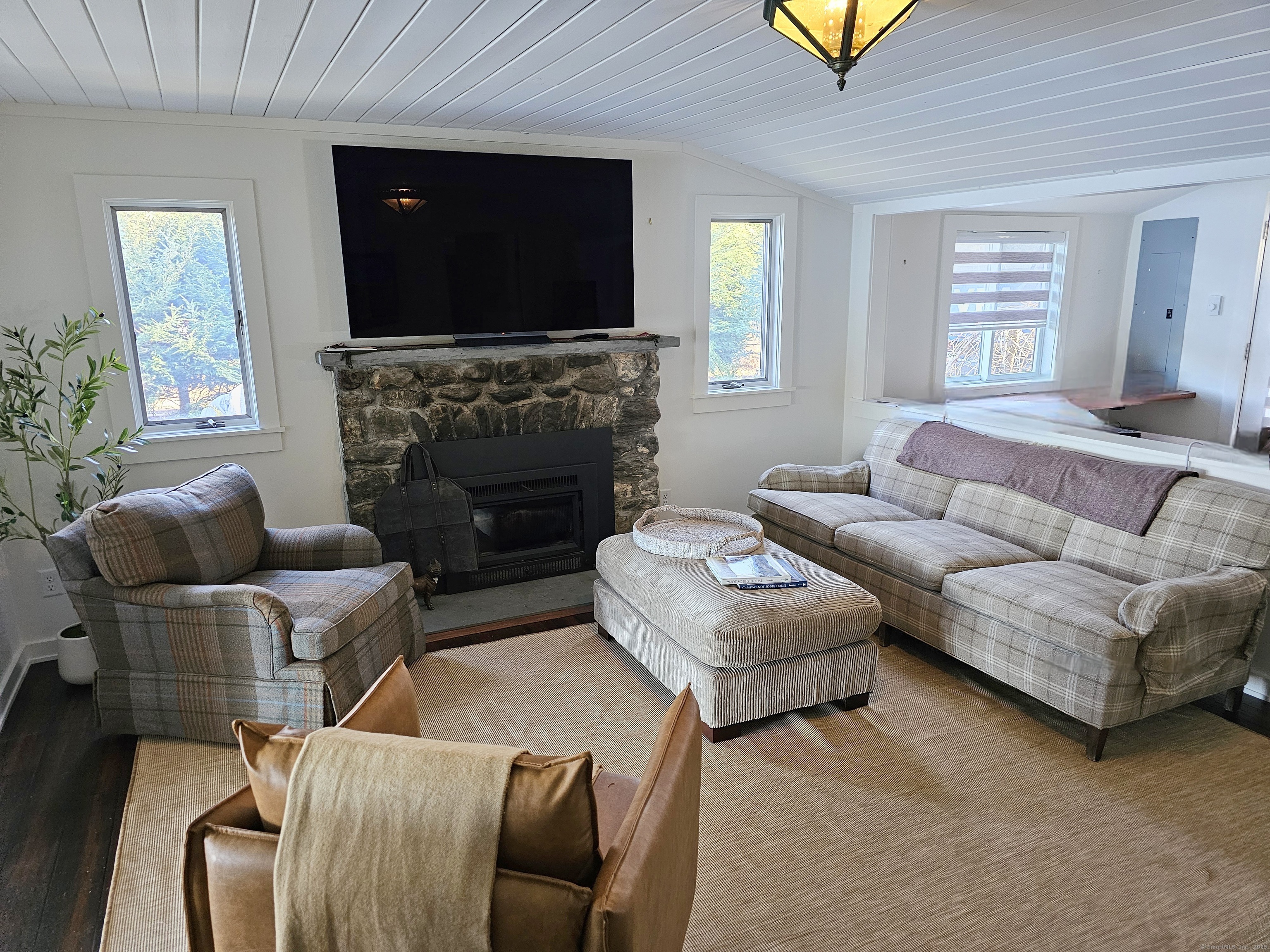 112 West Lake Road, Unit 112 Woodbury, CT 06798 - Photo 13 of 34 a living room with furniture and a flat screen tv