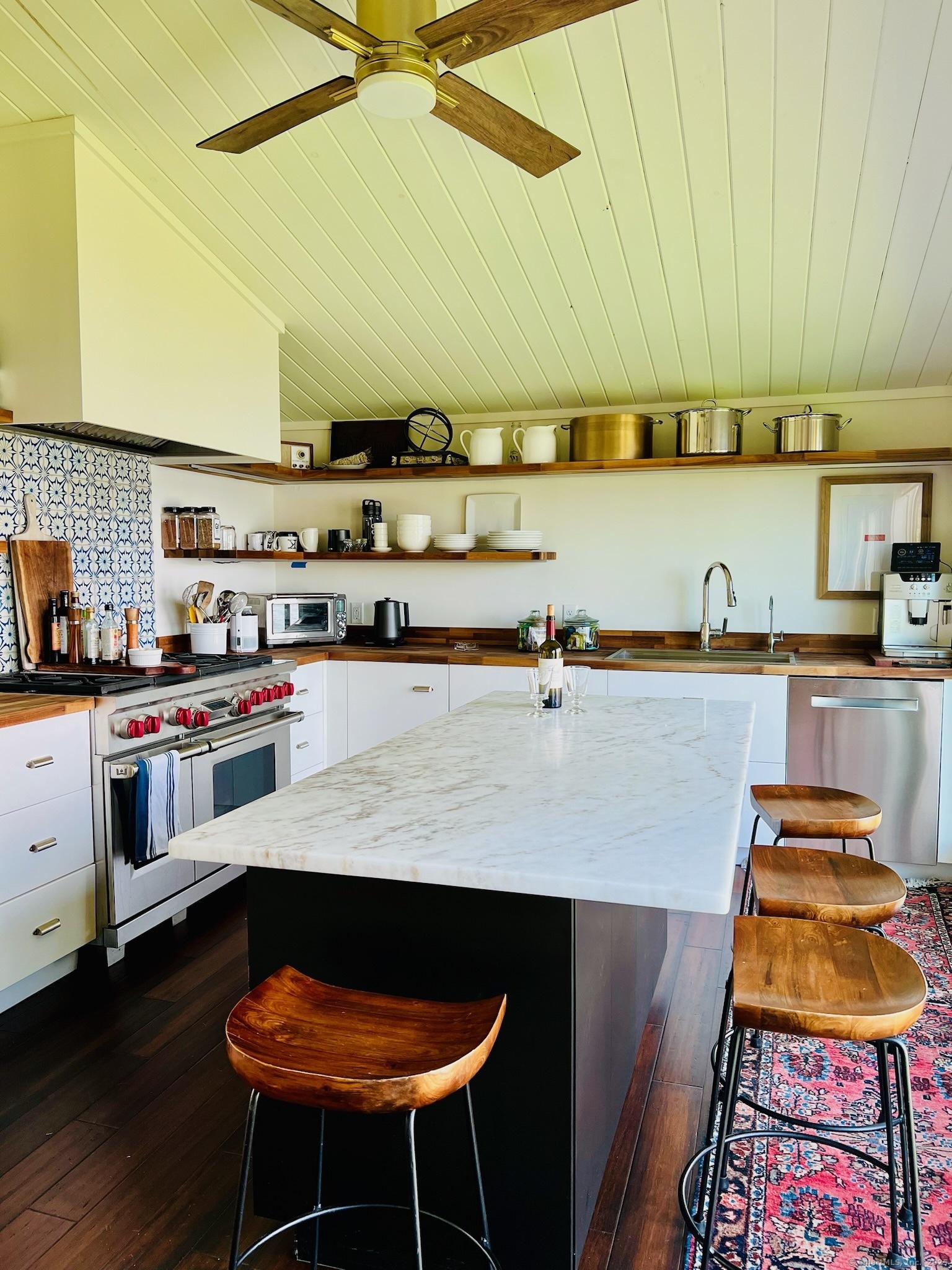 112 West Lake Road, Unit 112 Woodbury, CT 06798 - Photo 15 of 34 a kitchen with stainless steel appliances cabinets and a table