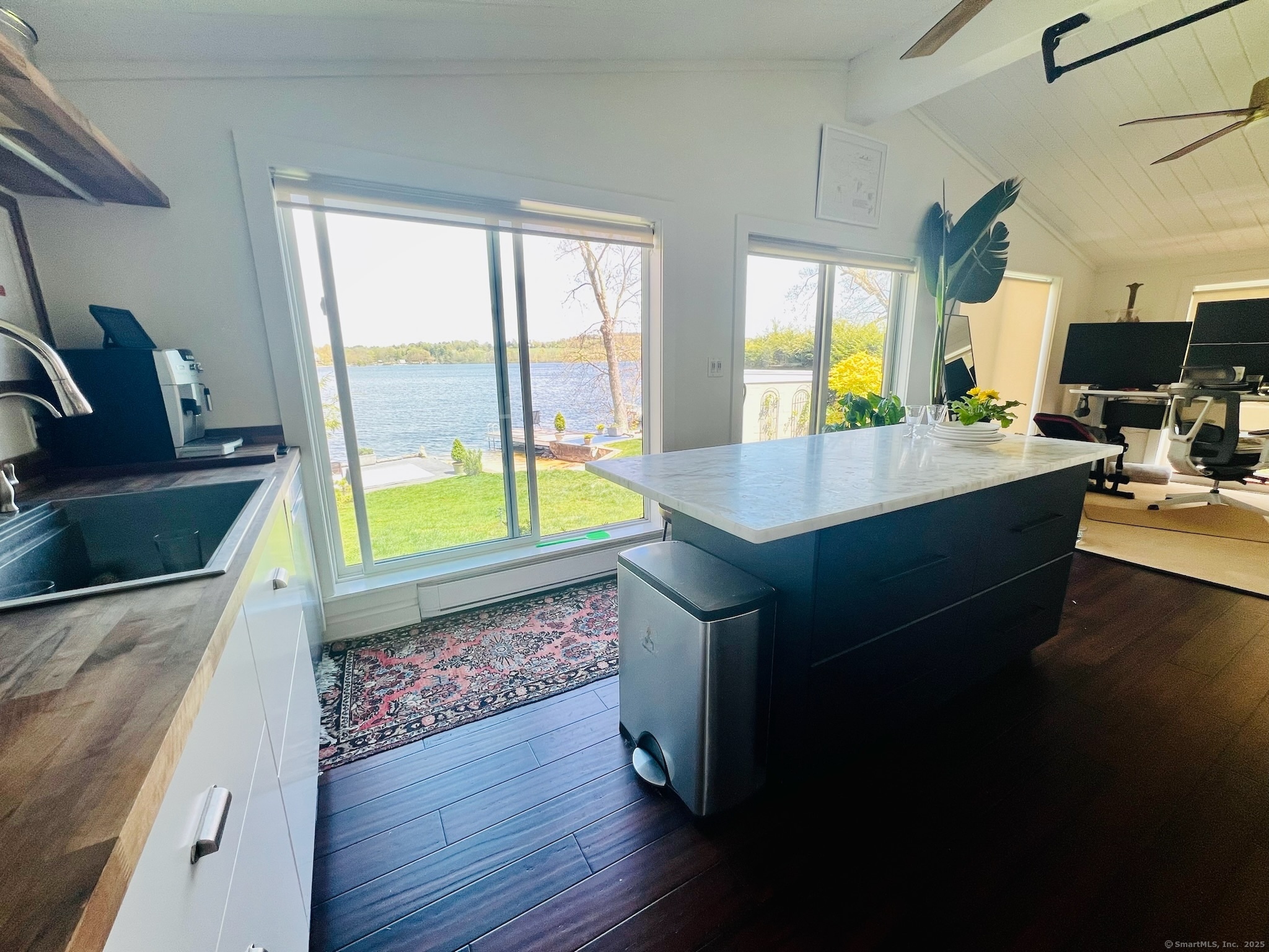 112 West Lake Road, Unit 112 Woodbury, CT 06798 - Photo 16 of 34 a living room with a large window and kitchen view