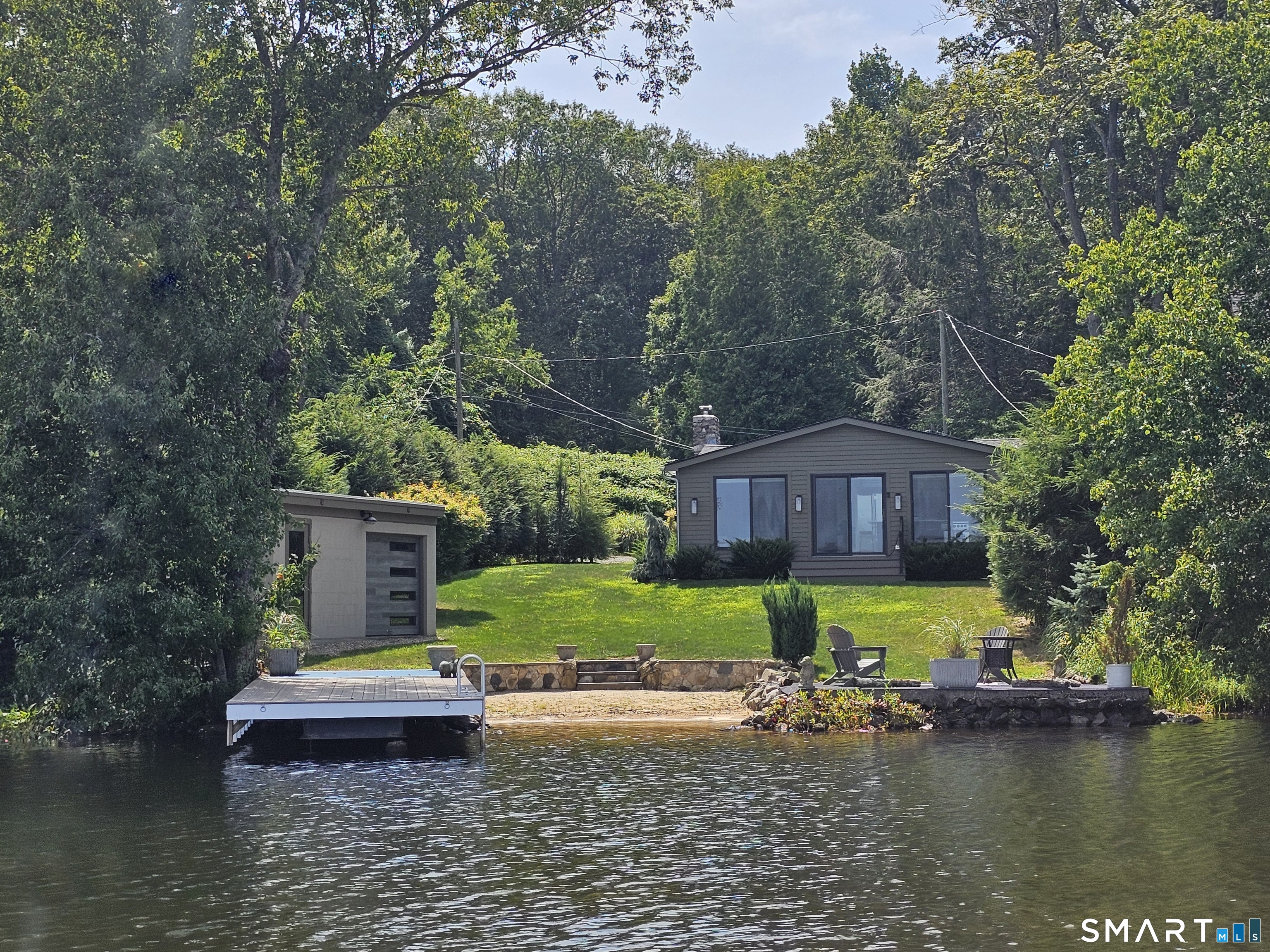 112 West Lake Road, Unit 112 Woodbury, CT 06798 - Photo 2 of 34 a view of a house with a yard and a large tree