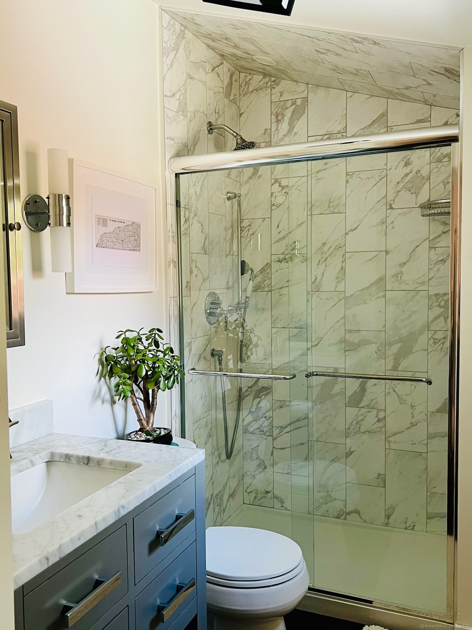 112 West Lake Road, Unit 112 Woodbury, CT 06798 - Photo 26 of 34 a bathroom with a sink a toilet and shower