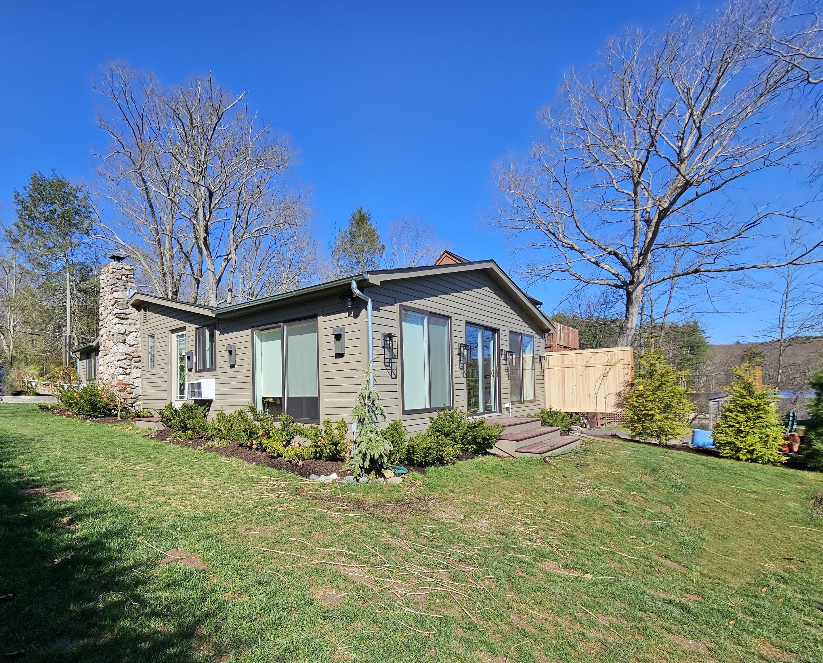 112 West Lake Road, Unit 112 Woodbury, CT 06798 - Photo 27 of 34 a front view of a house with garden