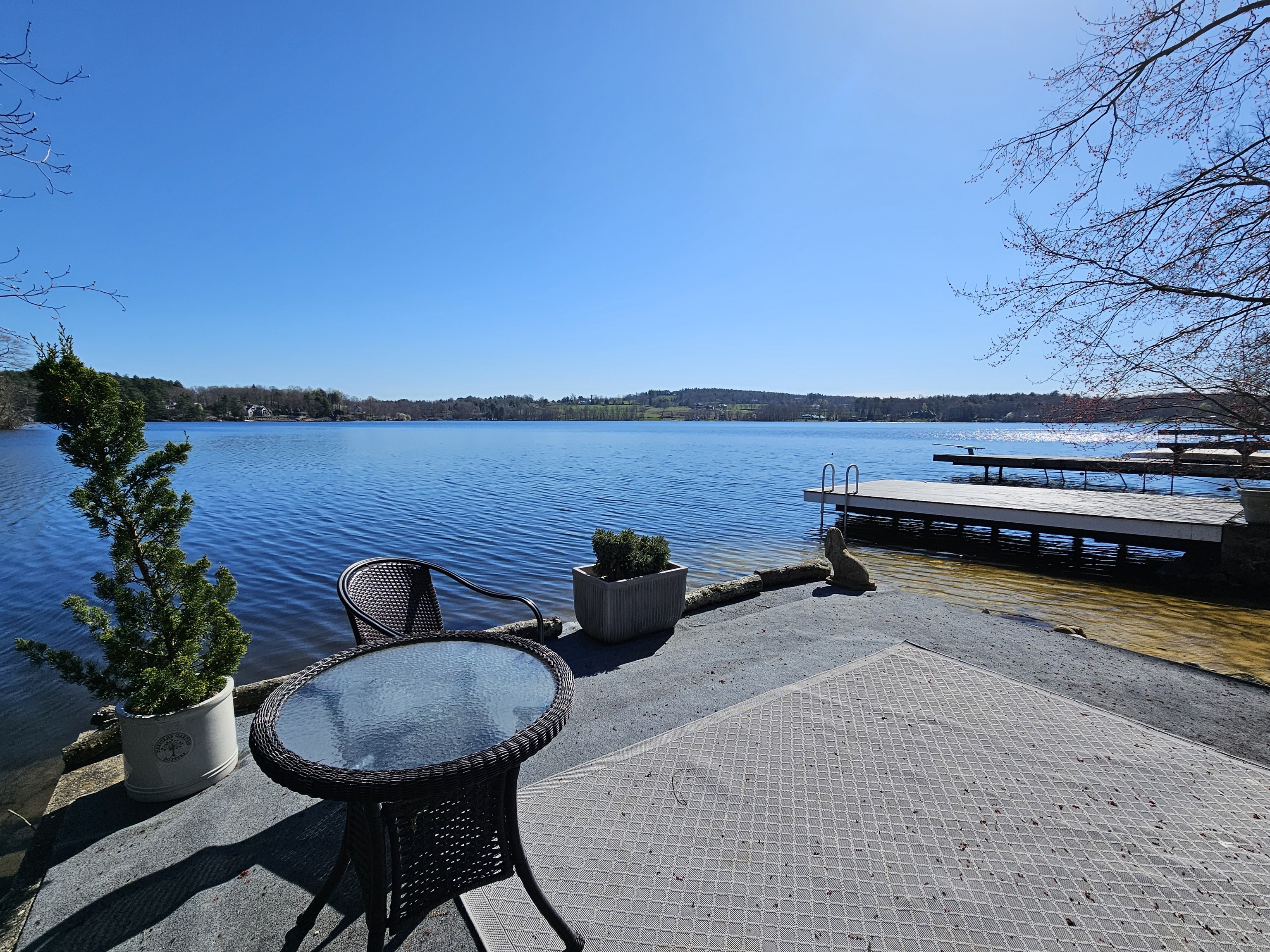 112 West Lake Road, Unit 112 Woodbury, CT 06798 - Photo 5 of 34 a view of a chairs and table in patio