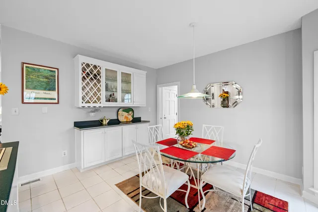 a kitchen with a table chairs and a stove