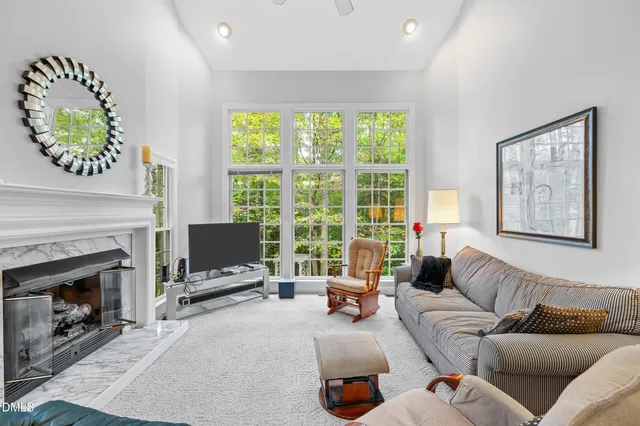 a living room with furniture a window and a fireplace