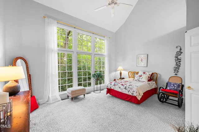 a bedroom with bed and a large window