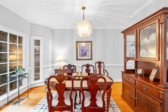 a view of a dining room with furniture large windows and wooden floor