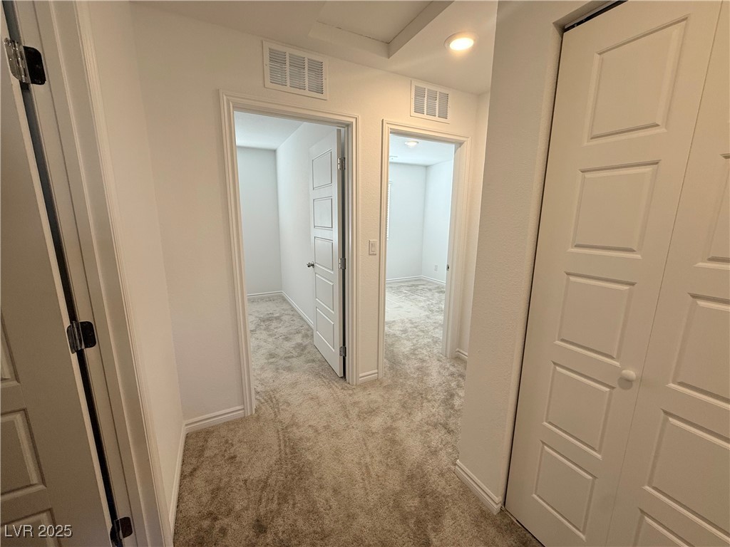 10772 Astell Isle Court Las Vegas, NV 89166 - Photo 13 of 32 Corridor featuring light colored carpet and baseboards