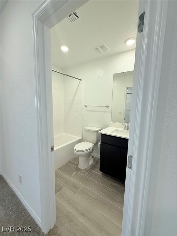10772 Astell Isle Court Las Vegas, NV 89166 - Photo 14 of 32 Bathroom featuring wood tiled floors, vanity, tub / shower combination, and recessed lighting