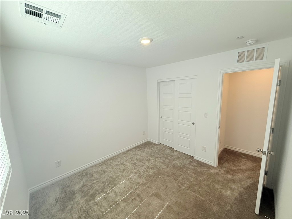 10772 Astell Isle Court Las Vegas, NV 89166 - Photo 18 of 32 Unfurnished bedroom with carpet flooring and a closet