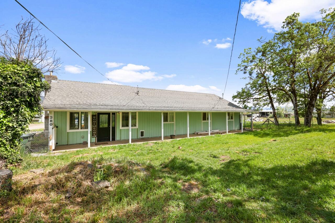 380 Greenleaf Drive Eagle Point, OR 97524 - Photo 2 of 31 front view of a house with a garden
