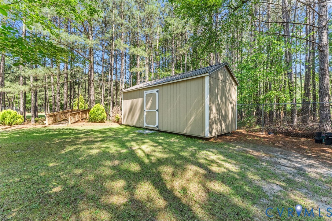 3120 Denise Road Petersburg, VA 23805 - Photo 5 of 51 Backyard featuring a gabled storage shed with a pa