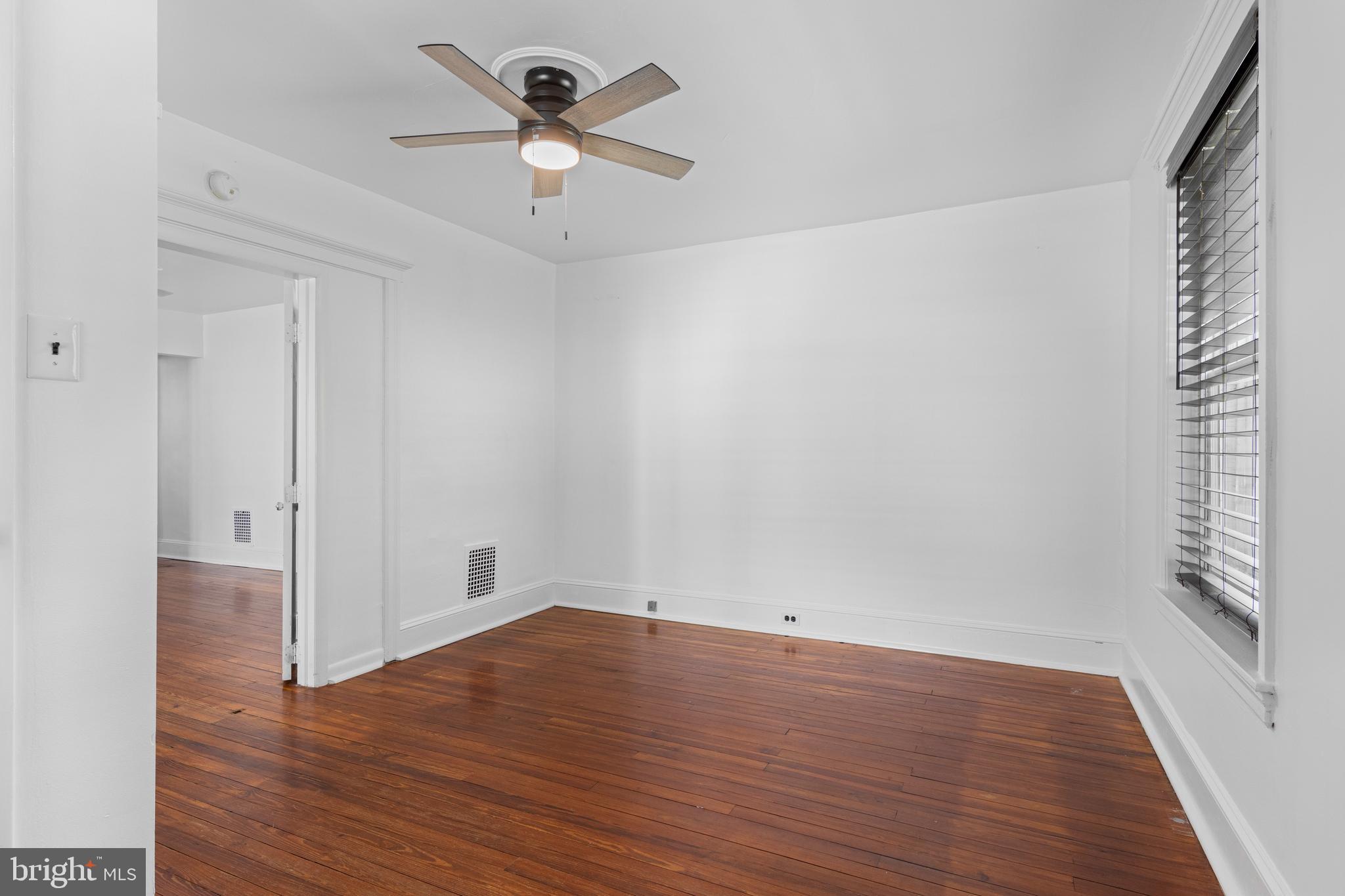 153 Conestoga Road Wayne, PA 19087 - Photo 9 of 13 an empty room with wooden floor and windows