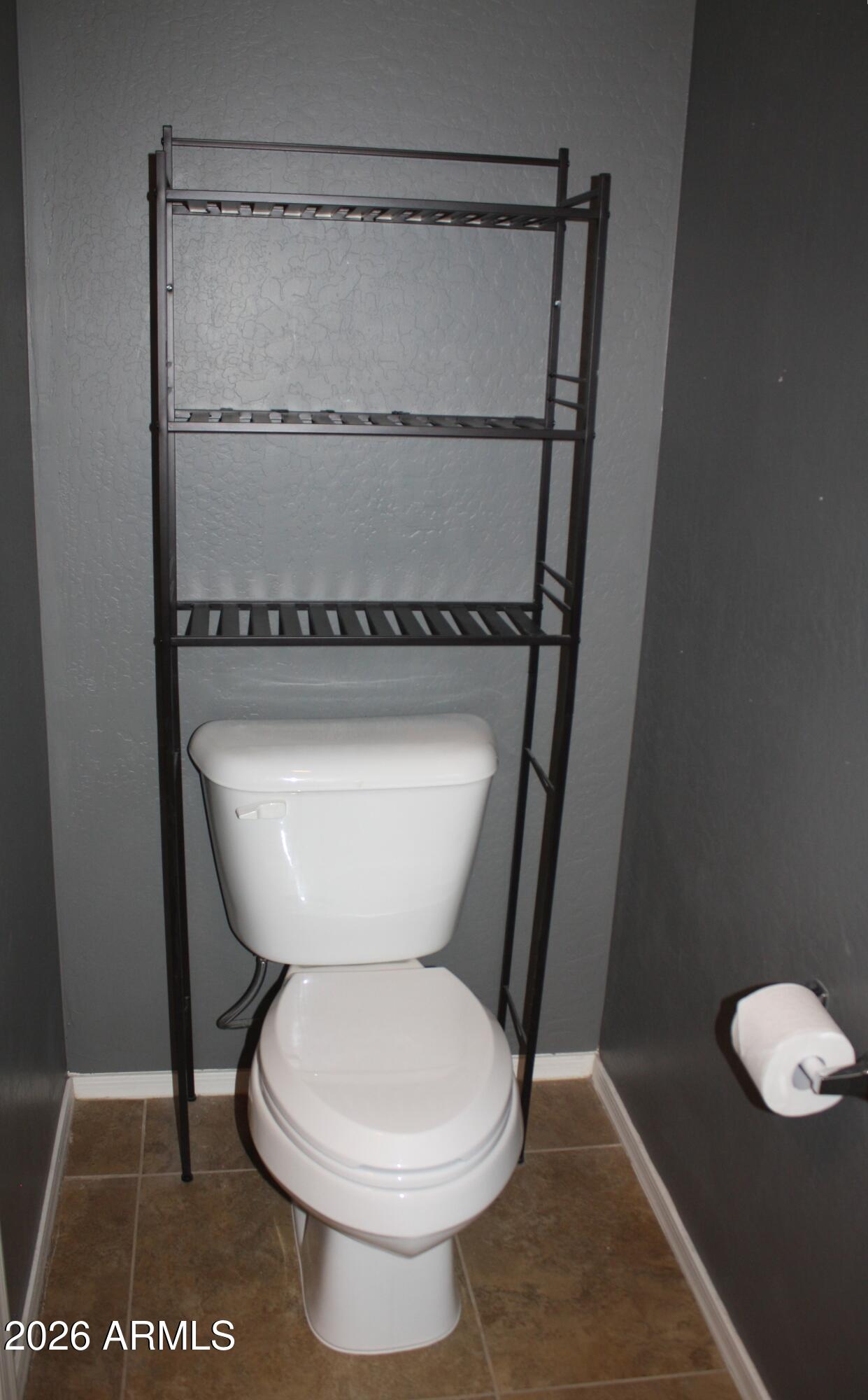 10225 West Camelback Road, Unit 19 Phoenix, AZ 85037 - Photo 17 of 51 a bathroom with a toilet and a shower
