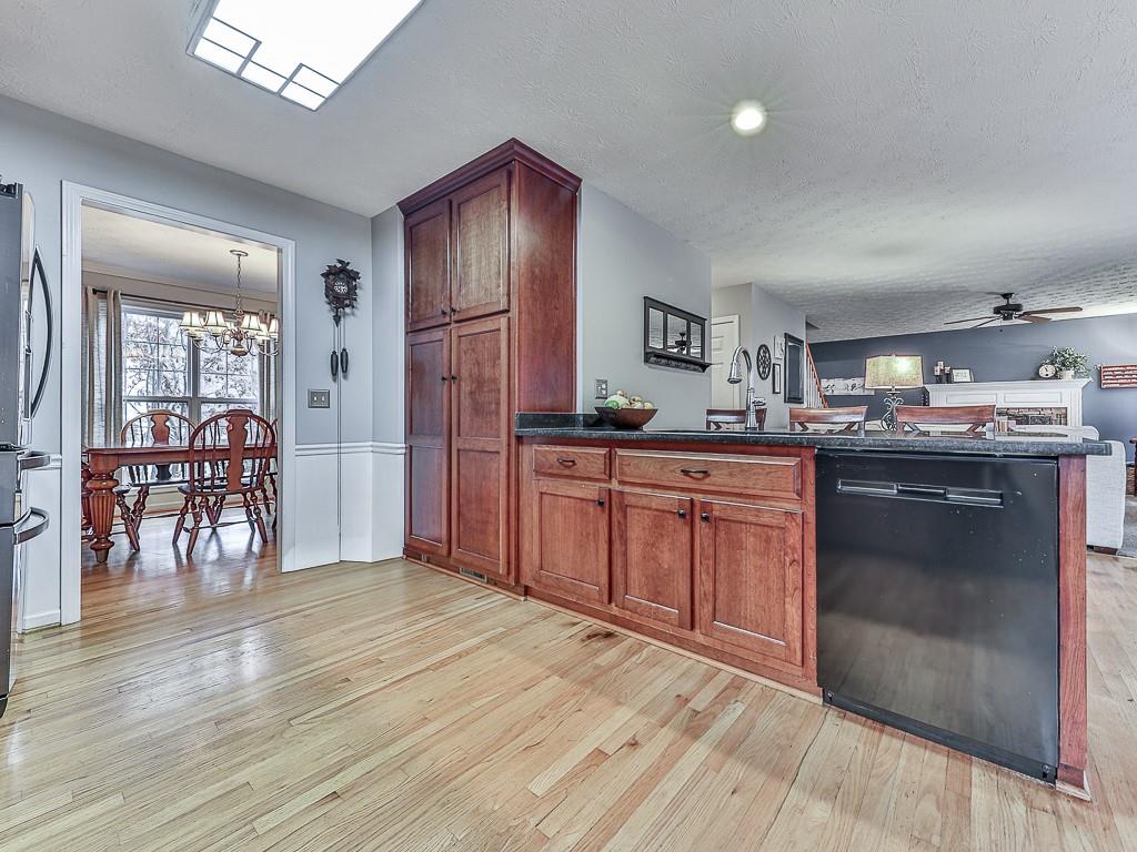 1108 Fieldstone Drive Canton, GA 30114 - Photo 15 of 40 a kitchen with stainless steel appliances granite countertop a refrigerator a sink dishwasher a stove with wooden cabinets and floor