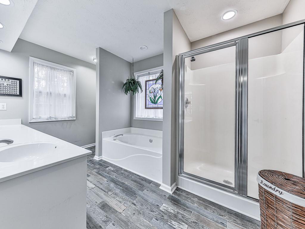 1108 Fieldstone Drive Canton, GA 30114 - Photo 30 of 40 a bathroom with a tub shower vanity and a sink