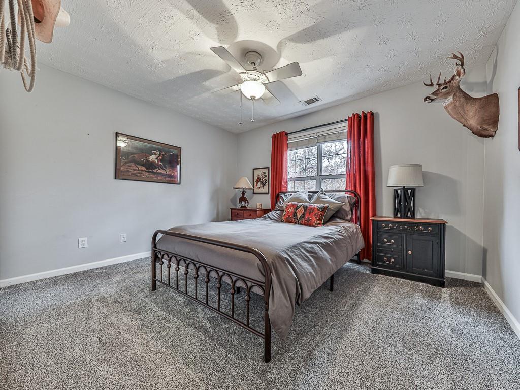 1108 Fieldstone Drive Canton, GA 30114 - Photo 35 of 40 a bedroom with a bed and a chandelier