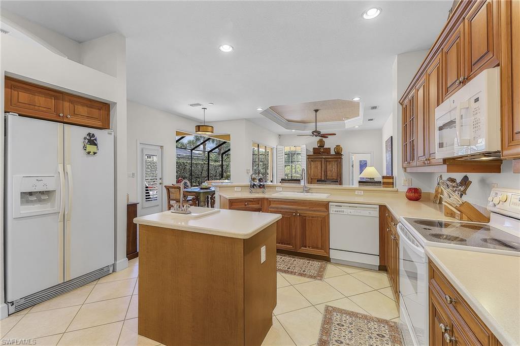 20187 Buttermere Court Estero, FL 33928 - Photo 23 of 40 a kitchen with stainless steel appliances granite countertop a sink stove and refrigerator