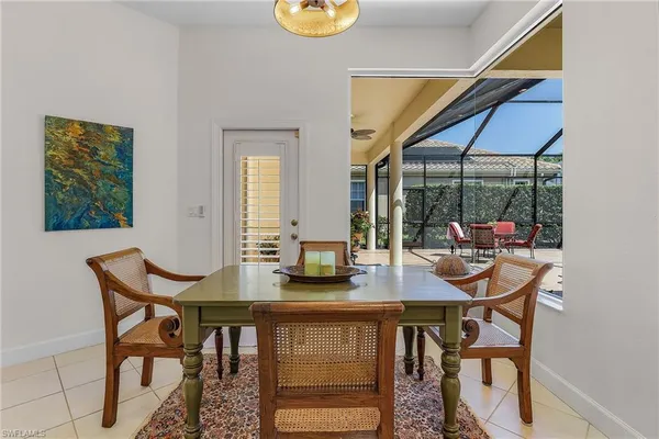 a view of a dining room with furniture wooden floor and a chandelier