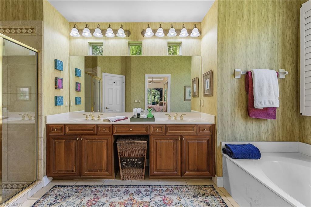 20187 Buttermere Court Estero, FL 33928 - Photo 32 of 40 a spacious bathroom with a sink and a mirror