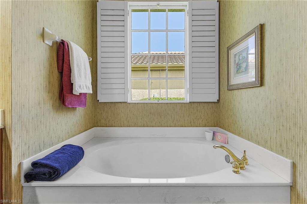 20187 Buttermere Court Estero, FL 33928 - Photo 34 of 40 a bathroom with a tub and a window