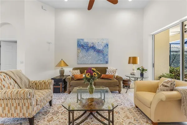 a living room with furniture ceiling fan and a rug
