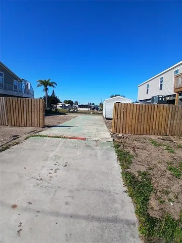 a view of a backyard with wooden fence