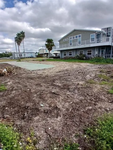 a view of front of house with yard and car parked
